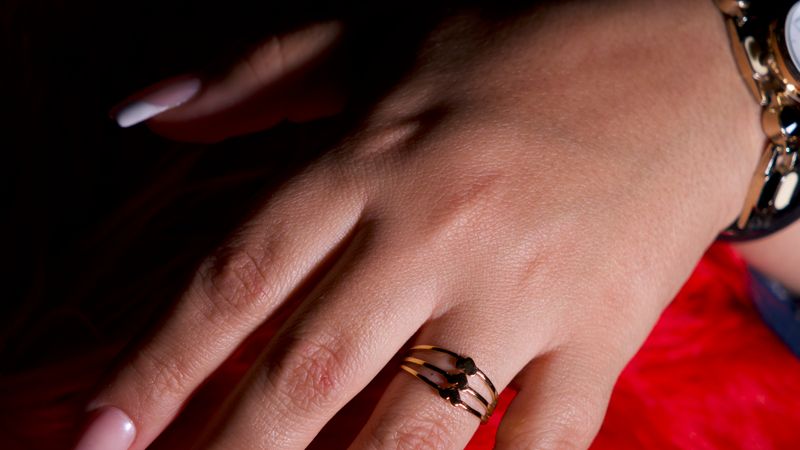 A hand with a freshly painted French manicure.