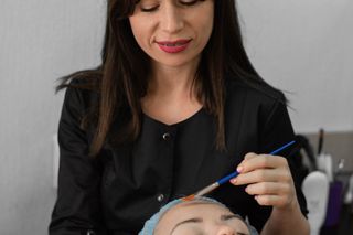 A facialist during a treatment session