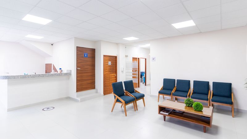 Small waiting area with a bench and chairs
