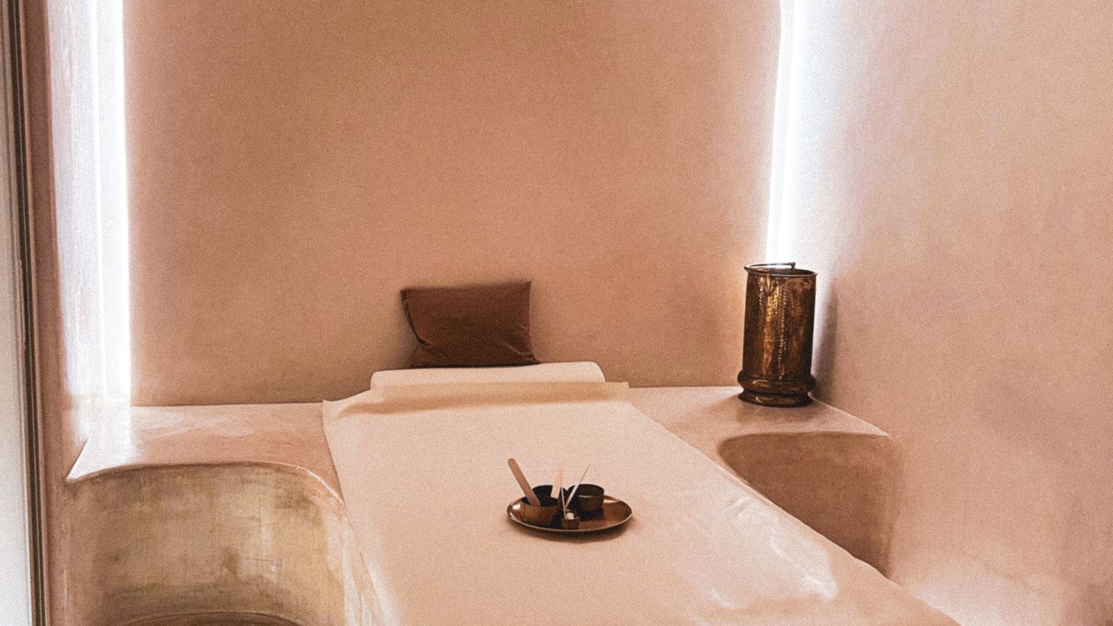 A luxury spa interior with loungers and a soaking bath