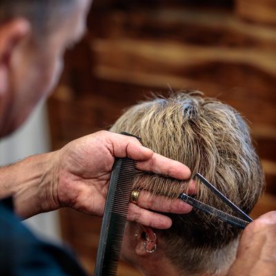 Client having their hair cut, finishing the look