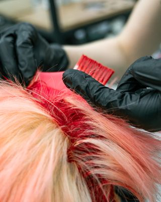 Hair colour being applied with a brush