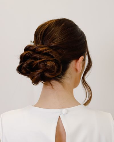 A half-up bridal hairstyle finished with soft curls