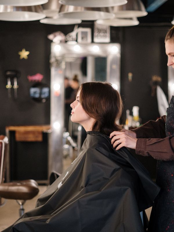 A client settling into the chair before her colour appointment