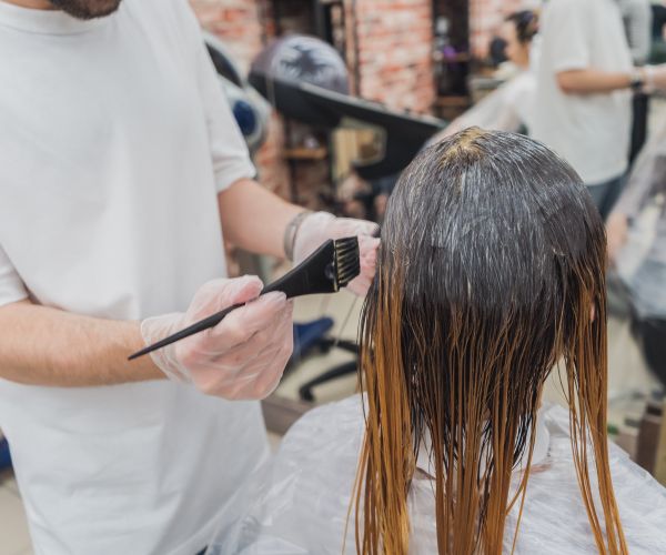 A colourist painting colour through from root to length