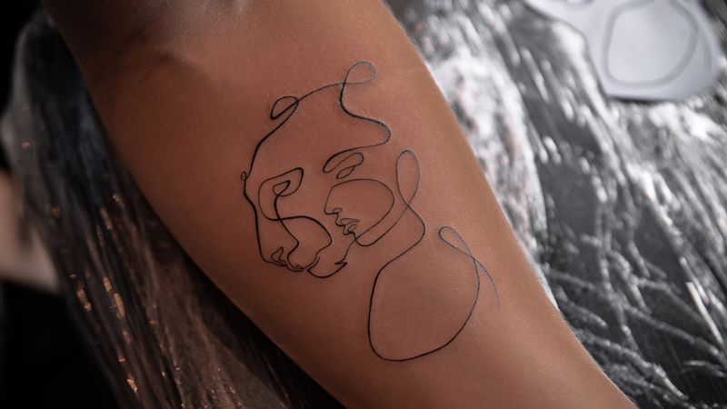 Close-up of healed fine-line tattoo work