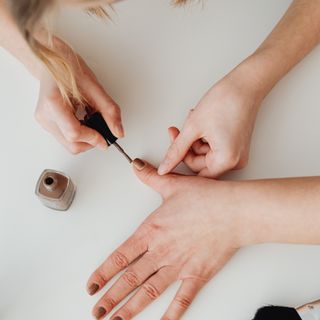 Technician painting a client's nails